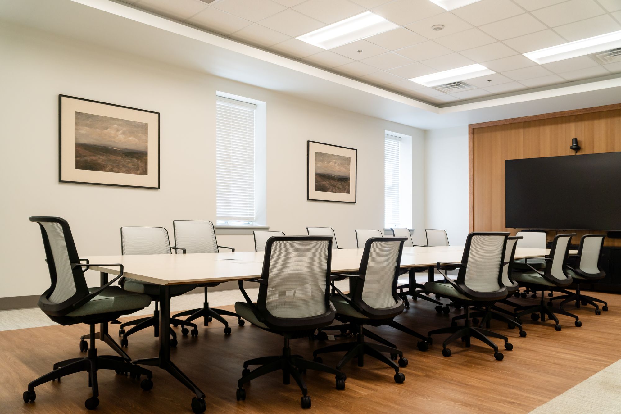 The Legacy Wellness Center conference room with a 14-foot table, ergonomic chairs, and presentation display