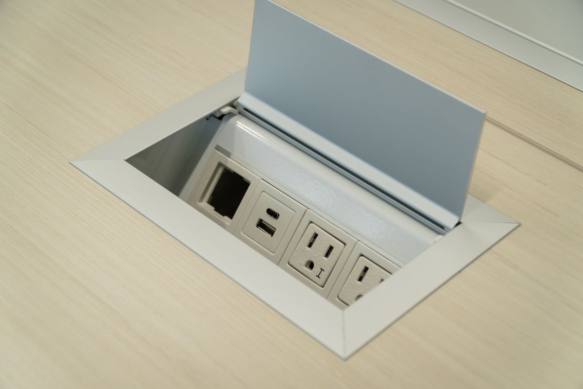 Built-in pop-up power and connectivity outlets in the conference table