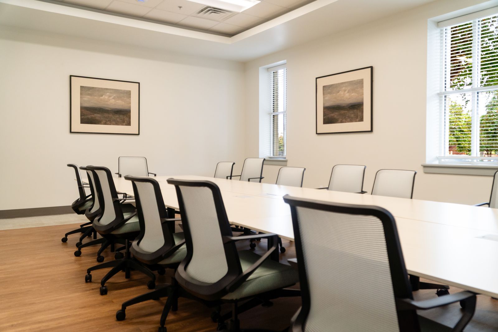 Conference room seating with ergonomic chairs and natural light